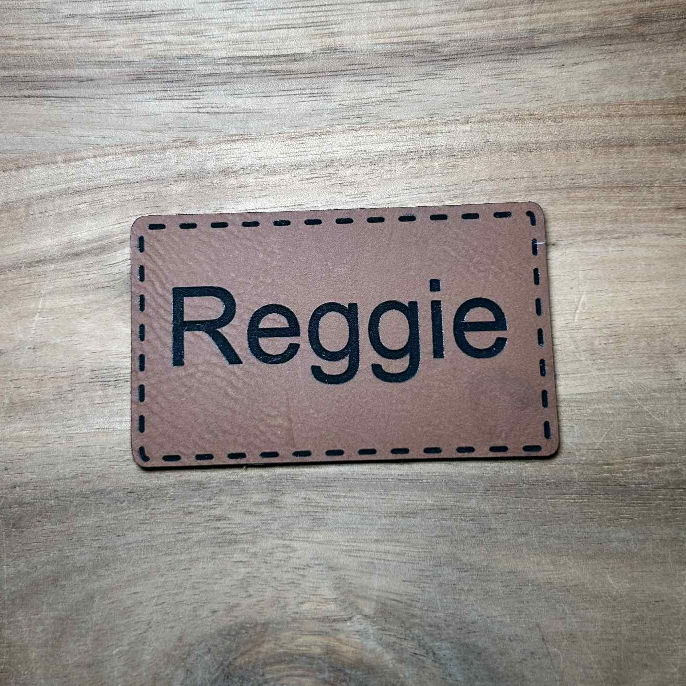 personalized brown leather patch with the name Reggie engraved